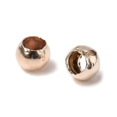 Rose gold round crimp beads 2mm warm blush rose gold plating open barrel shown bulk scattered close-up and ruler scale jewellery making Australia