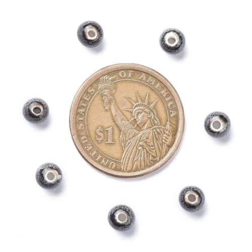 Porcelain round beads 6mm dark speckled black grey volcanic glaze finish white porcelain bead hole shown bulk close-up ruler and coin scale jewellery making Australia